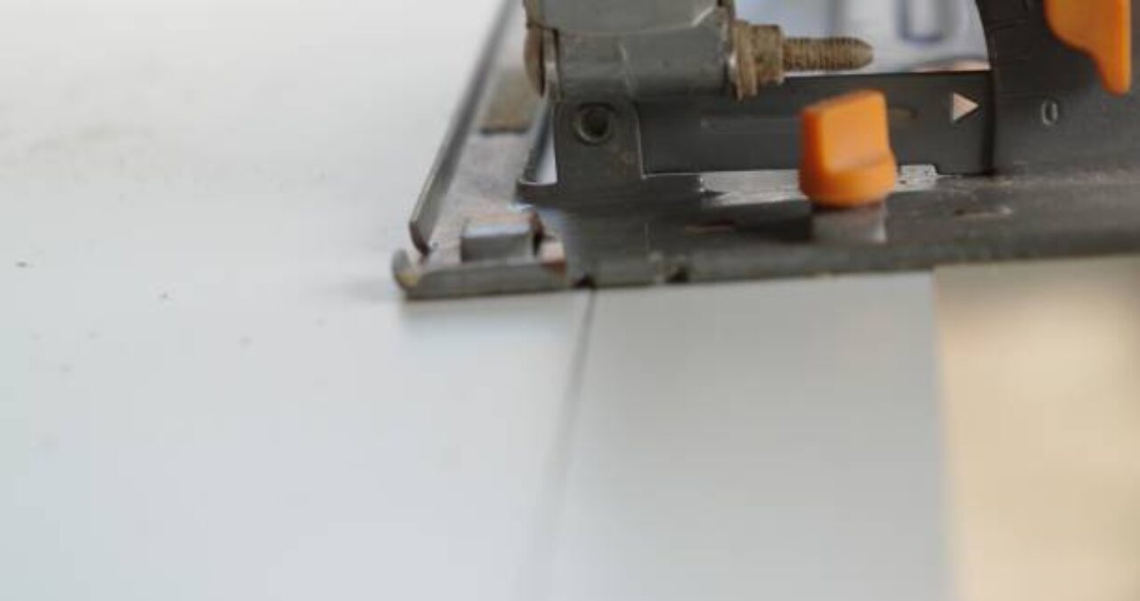 Close-up of a cutting tool making a precise cut on a surface, often needed for installing chemical-resistant coatings.