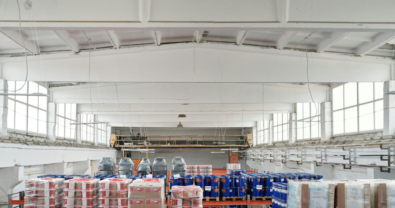 Bright industrial interior with white painted structural steel beams, showing the results of strategic Facility Upgrades During the Holidays.