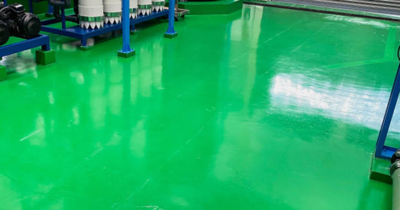 Seamless, bright green industrial floor coating, often finished with a durable Urethane topcoat for superior abrasion and chemical resistance.