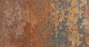Severely corroded industrial steel surface showing heavy orange rust and failing dark protective coating layers.