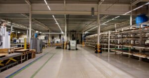 Interior of an active manufacturing plant featuring durable concrete floors coated in protective epoxy, complete with green and blue painted safety walkways