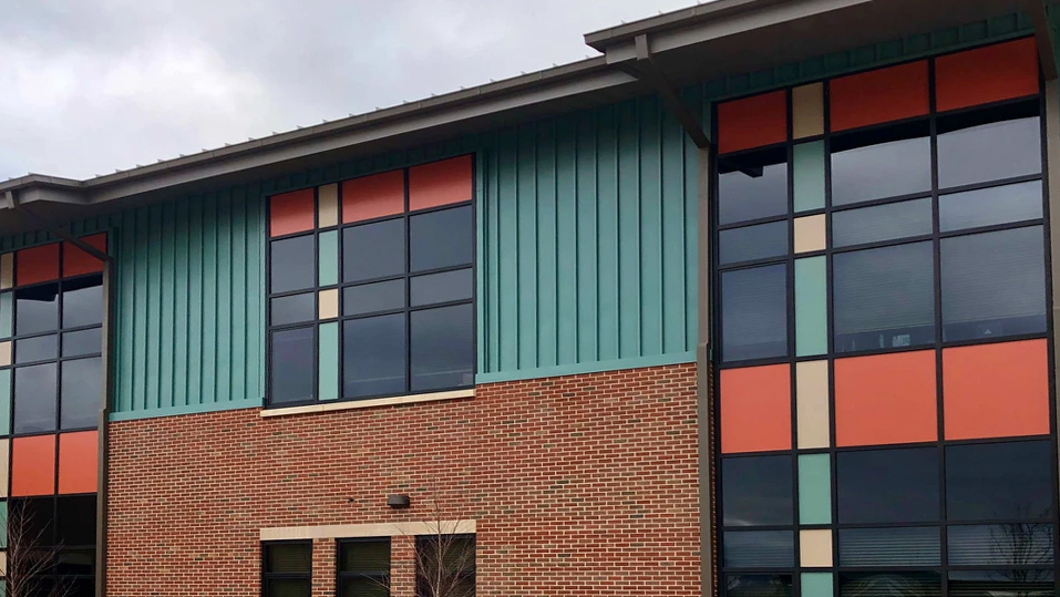 Exterior of East Brainerd Elementary school in Chattanooga Tennessee with colorful painted panels and brick facade completed by school painting contractor Southeast Painters