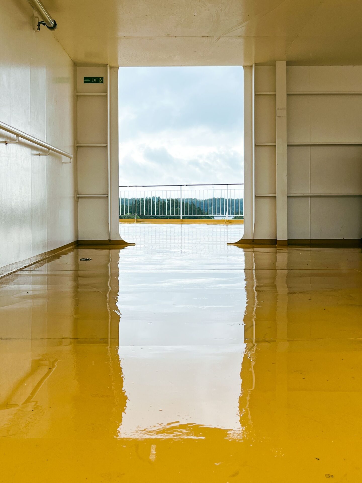 High-gloss yellow industrial epoxy floor coating in a commercial facility showing a durable and seamless resinous flooring finish